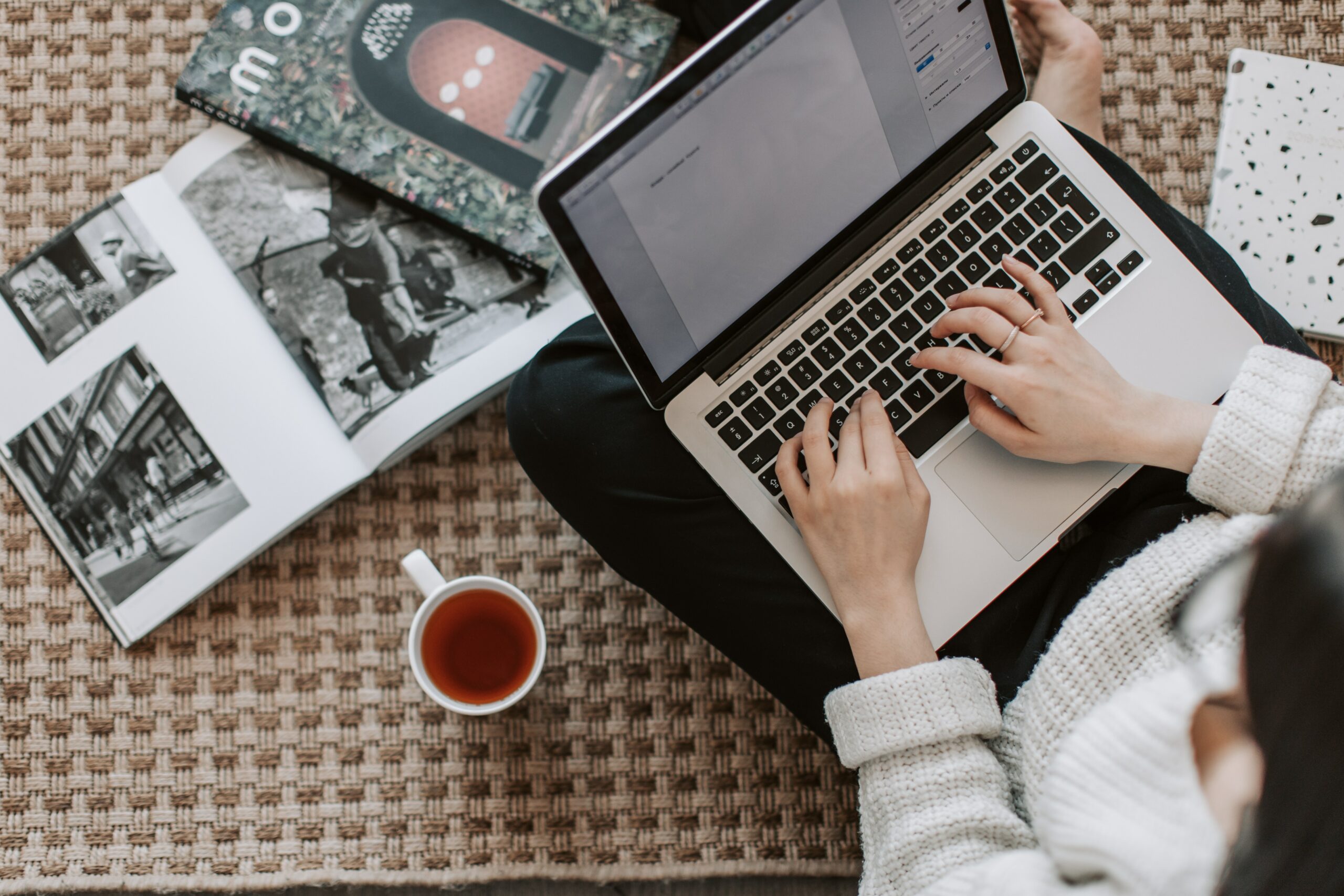 Stock Image -Vertical shot of person using laptop on lap.