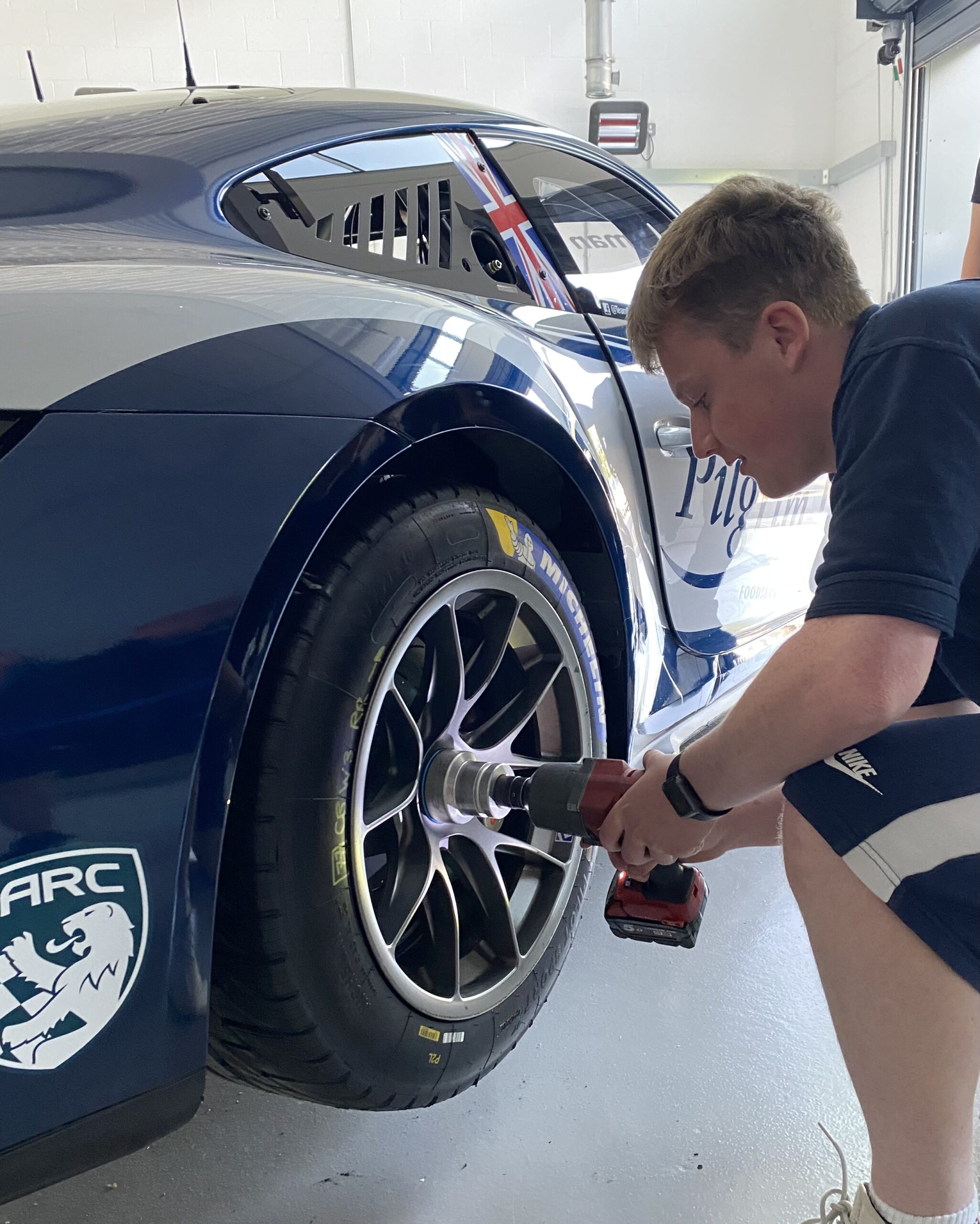 Motorsport Learner Changing Wheel on Pilgrim Foods Porchse