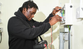 Boston College Electrical student performing electrical testing