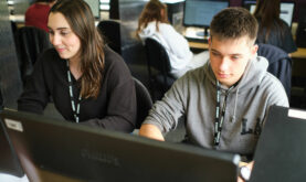 Two Boston College Business student studying in the College library on computers