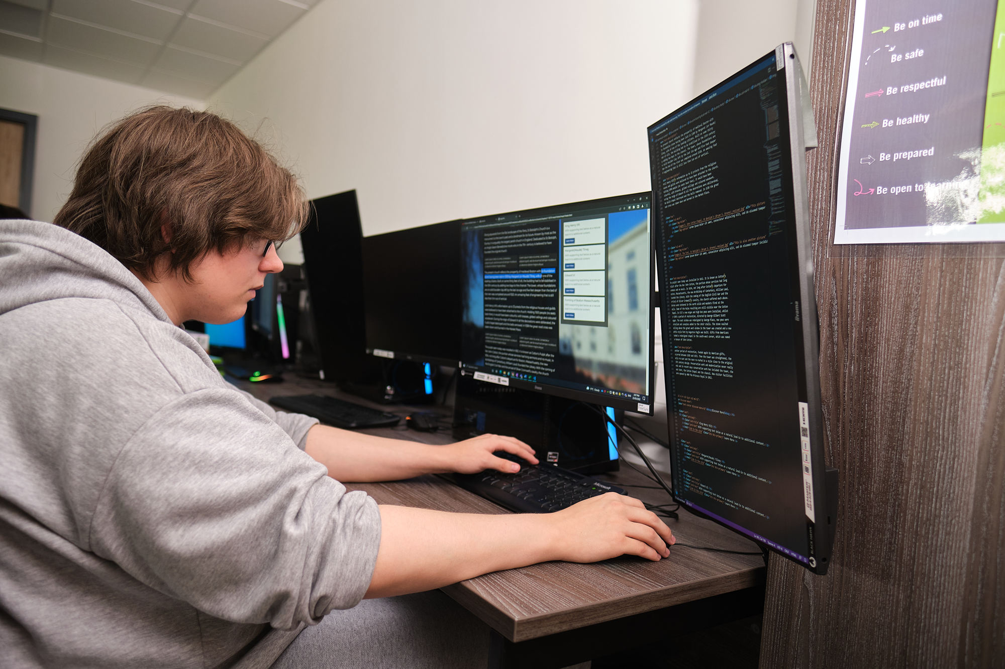 Boston College Digital Technologies student using a dual screen computer to code