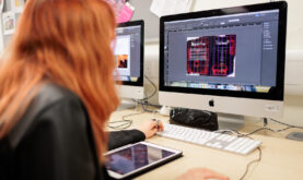 Boston College Graphic Design Learner creating designs on an APple Mac