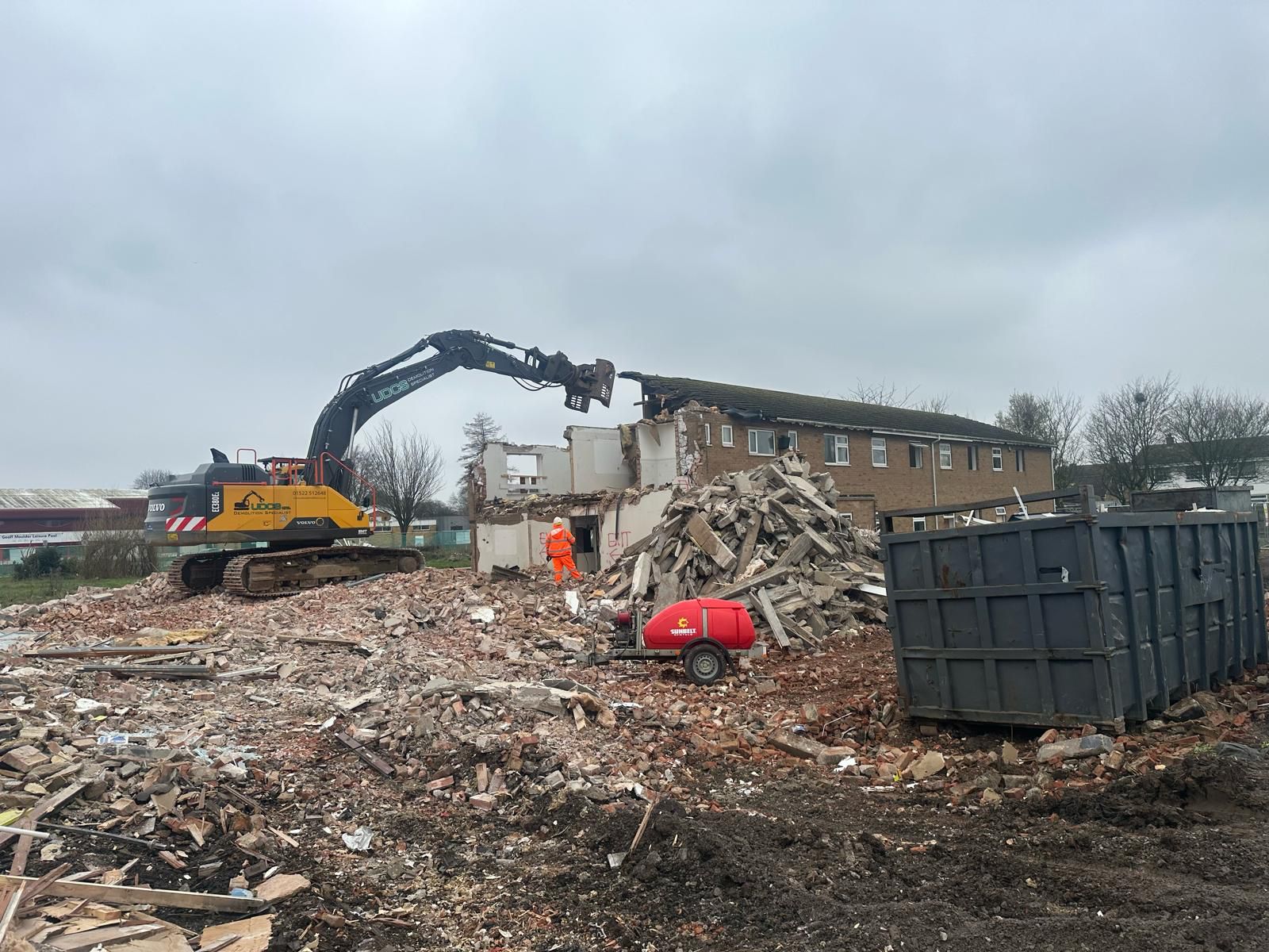 Photo of Boston College Ingelow Centre being demolished using a excavator.