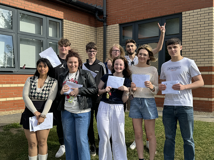Boston College Students holding A Level results, posing for group photo in front of Sixth Building