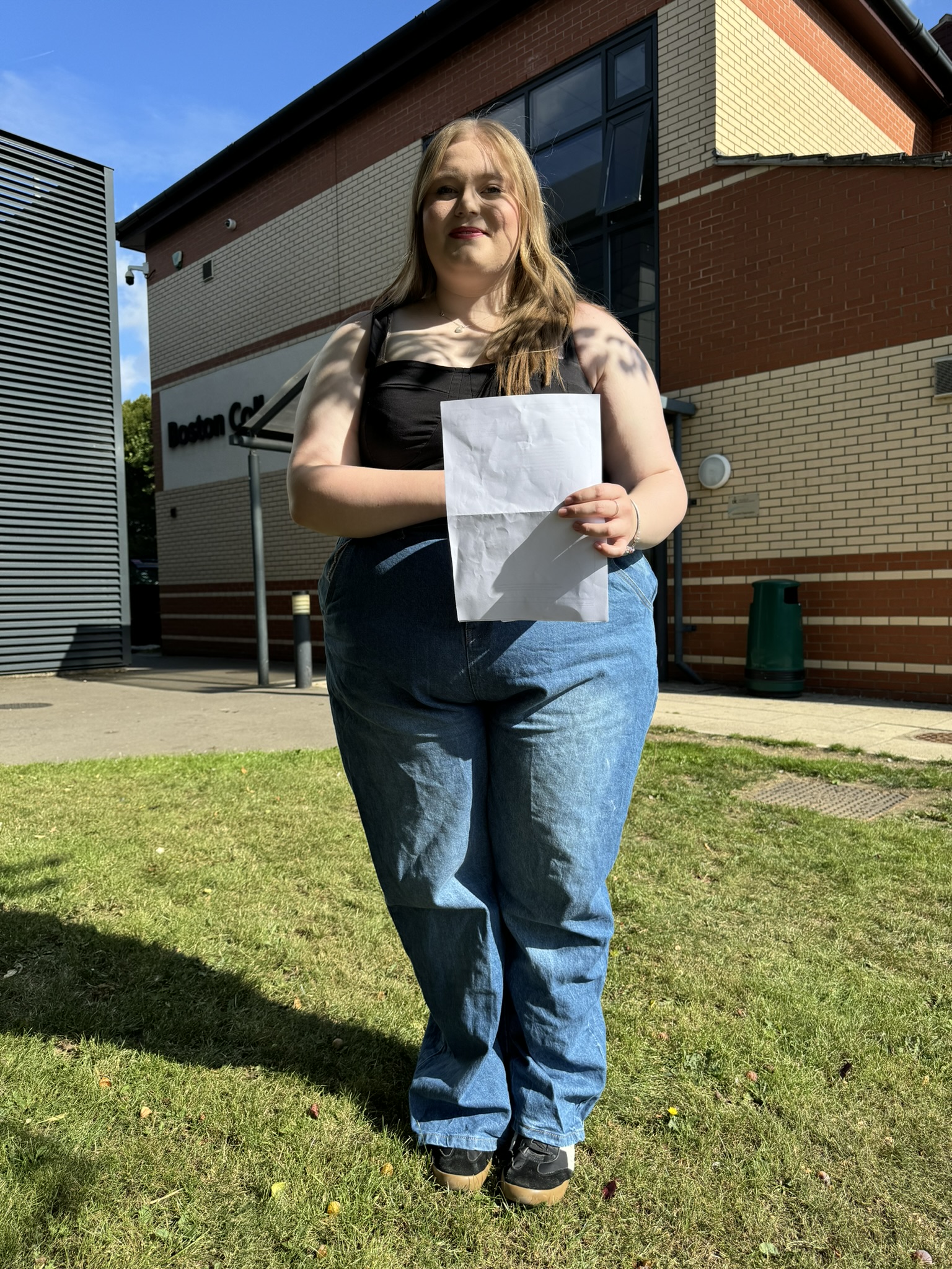 Boston College A Level Results Day 2025 A Level student Callie Sharp holding her results in front of the SIXTH building