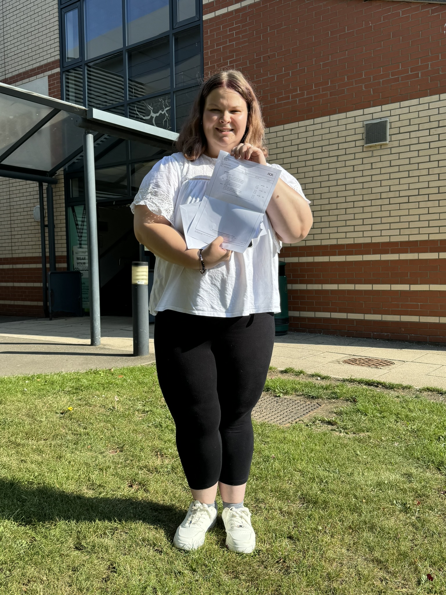 Boston College A Level Results Day 2025 A Level student Grace Vines holding her results in front of the SIXTH building