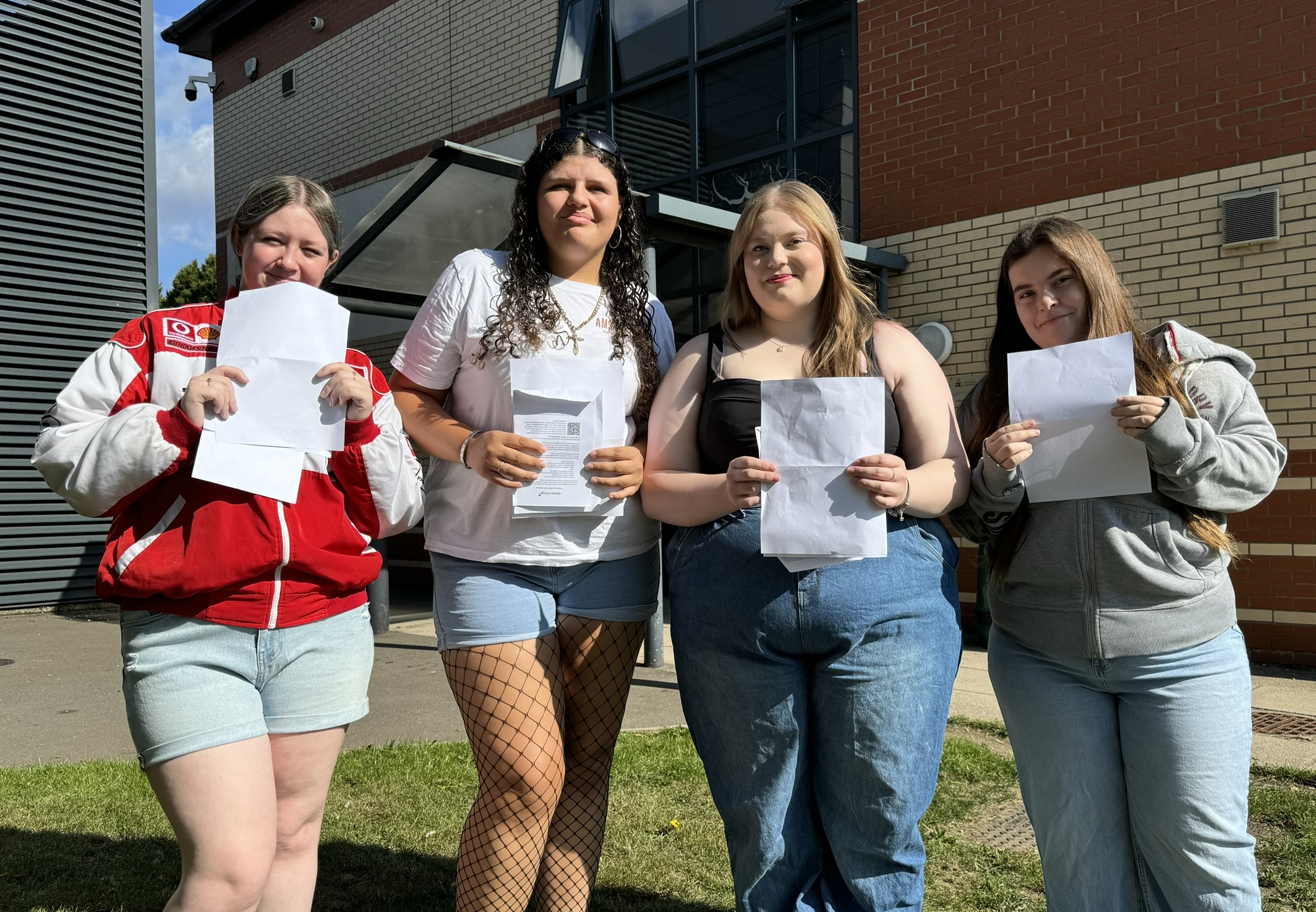 Boston College A Level Results Day 2025 group photo of students holding their results in front of the SIXTH building