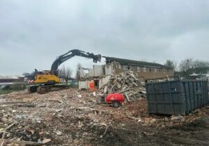 Photo of Boston College Ingelow Centre being demolished using a excavator.