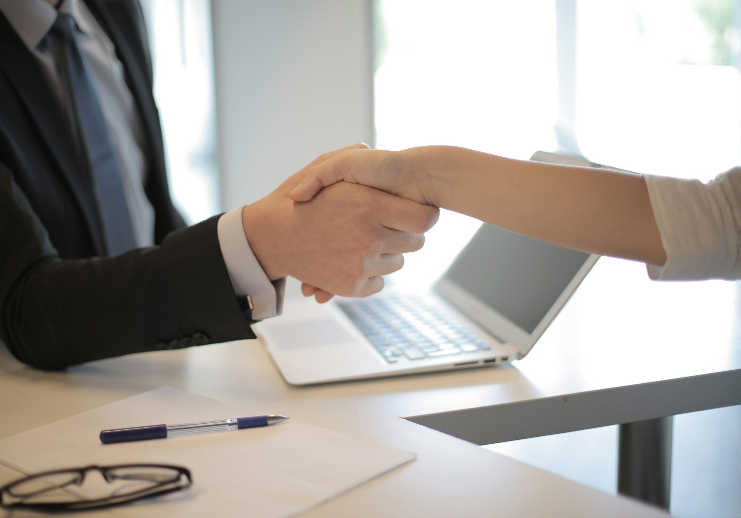 Stock image - a hand shake between two people